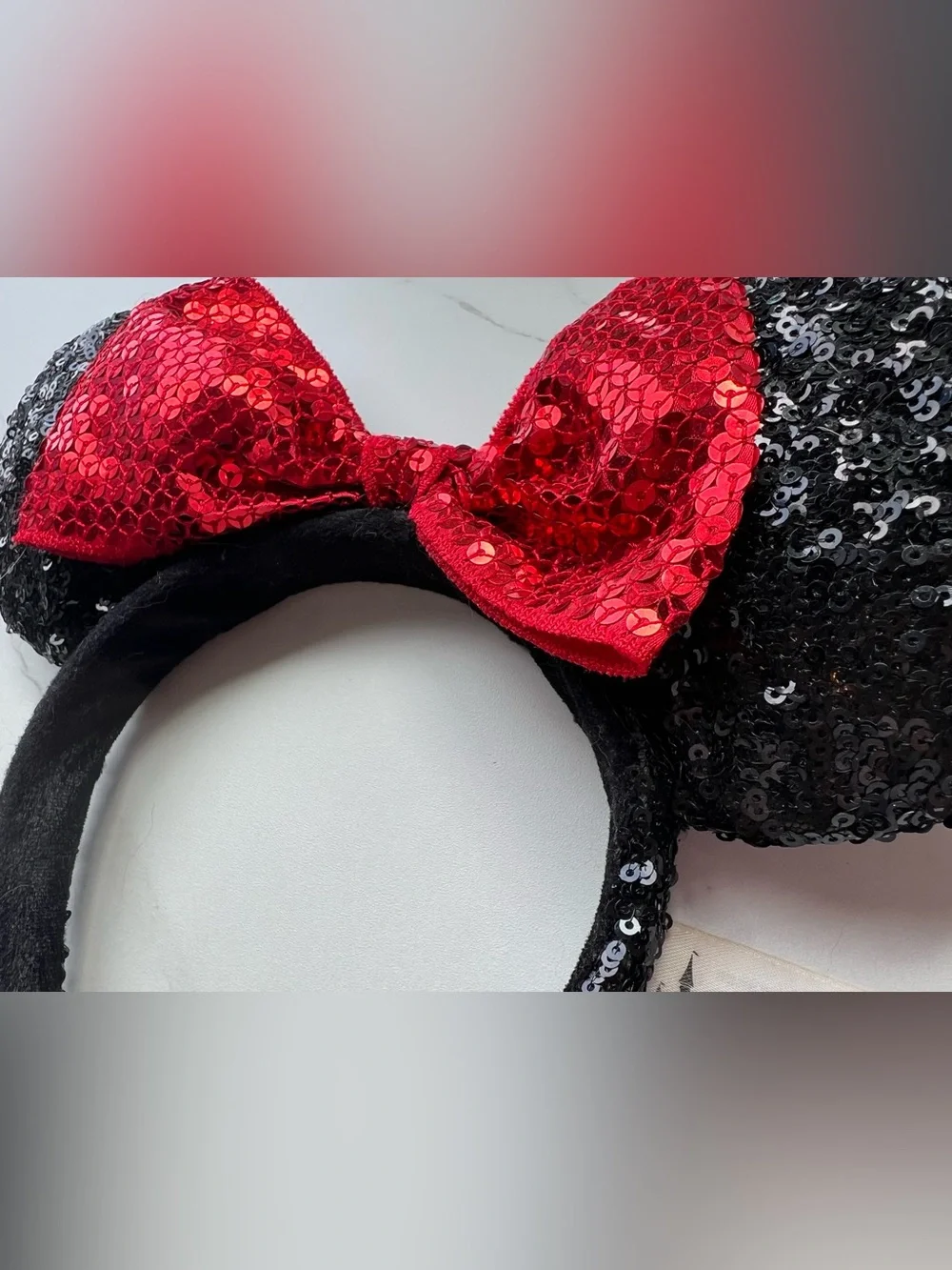 Disney Parks Authentic White Label, black sequin ears with a read sequin bow.